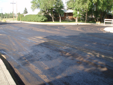 The first layer of asphalt drying on the road surface