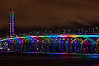 The Samuel De Champlain Bridge illuminated in rainbow colors every Sunday night at sunset