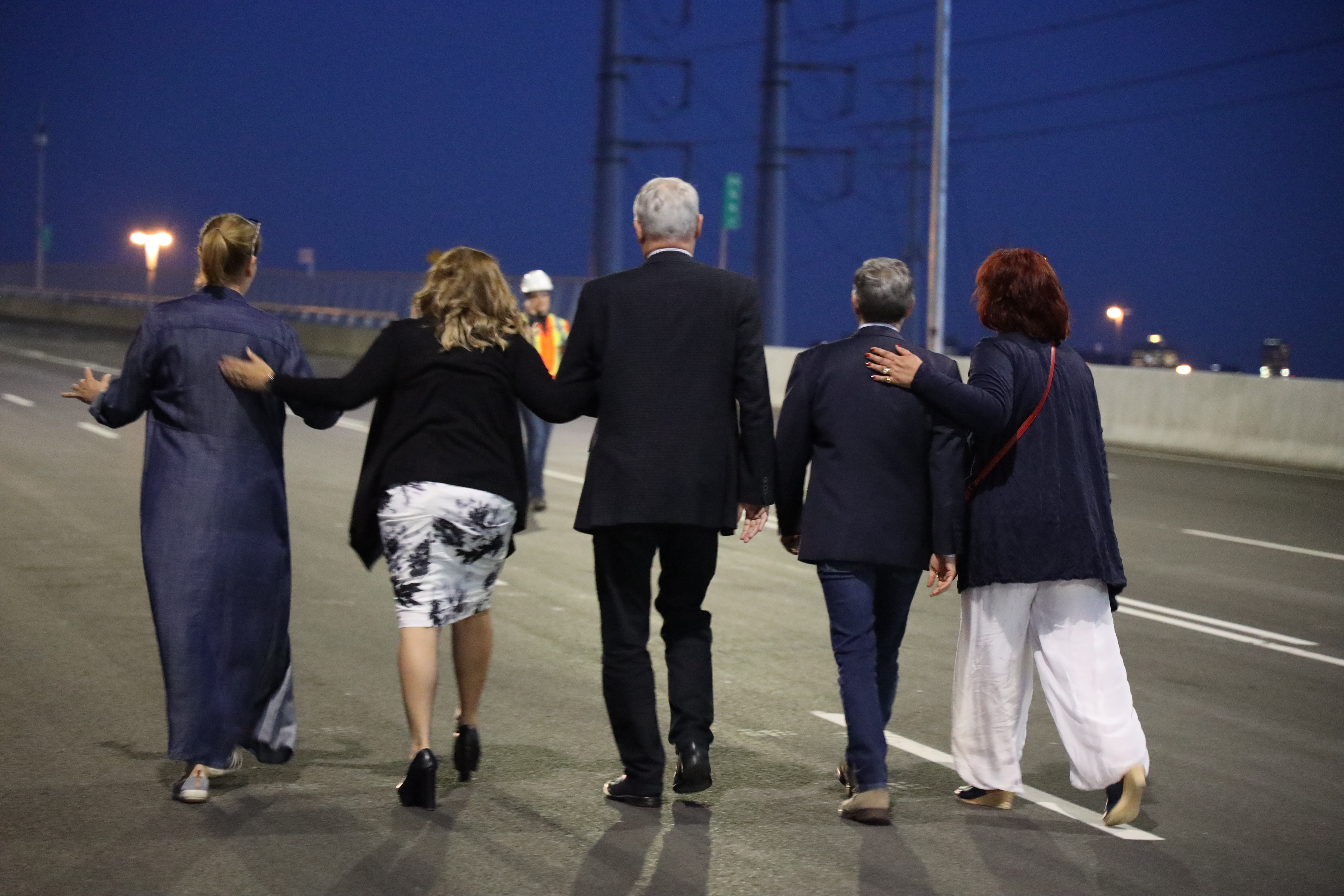 Doreen Assaad, Mayor of Brossard, Minister Marc Garneau, Minister François-Philippe Champagne, MP Alexandra Mendes walking on the deck of the Samuel De Champlain Bridge minutes before the first crossing 