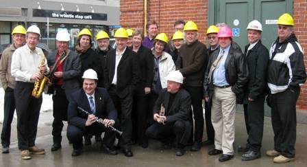 From left to right: Member of Provincial Parliament Jeff Leal (holding saxophone); Mayor Paul Ayotte (holding electric guitar); Member of Parliament Dean Del Mastro (holding clarinet); Market Hall Chairman Jim Angel (holding mandolin); and artists and community supporters.